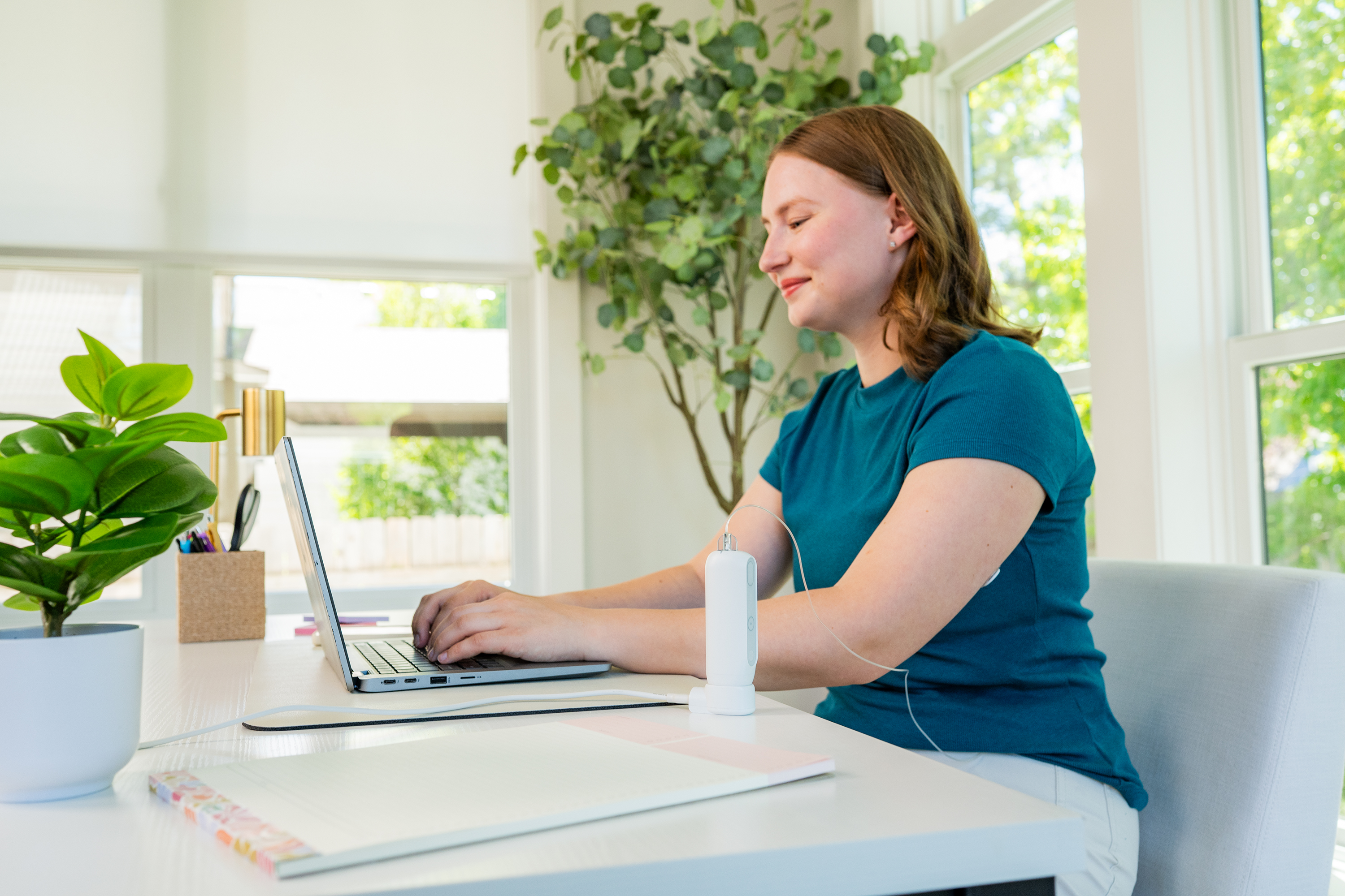 Healthcare professional using a laptop to manage digital patient orders in a medical office.